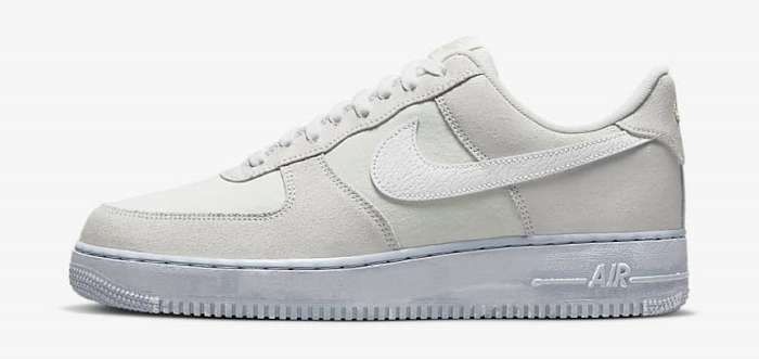 Side view of a white and grey Nike Air Force 1 shoe.